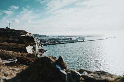 united kingdom brown cliff near sea under cloudy sky dover